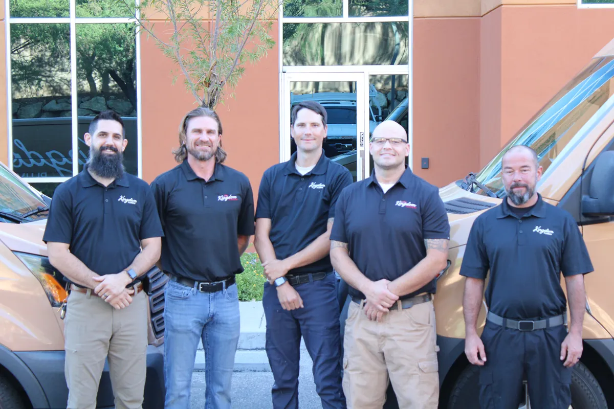 Five Kingdom Plumbing team members lined up in front of the Las Vegas office