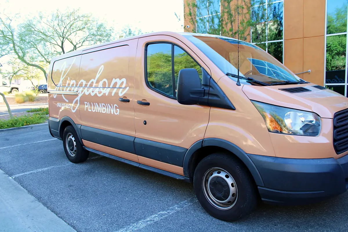 Kingdom Plumbing service van parked outside the Las Vegas office