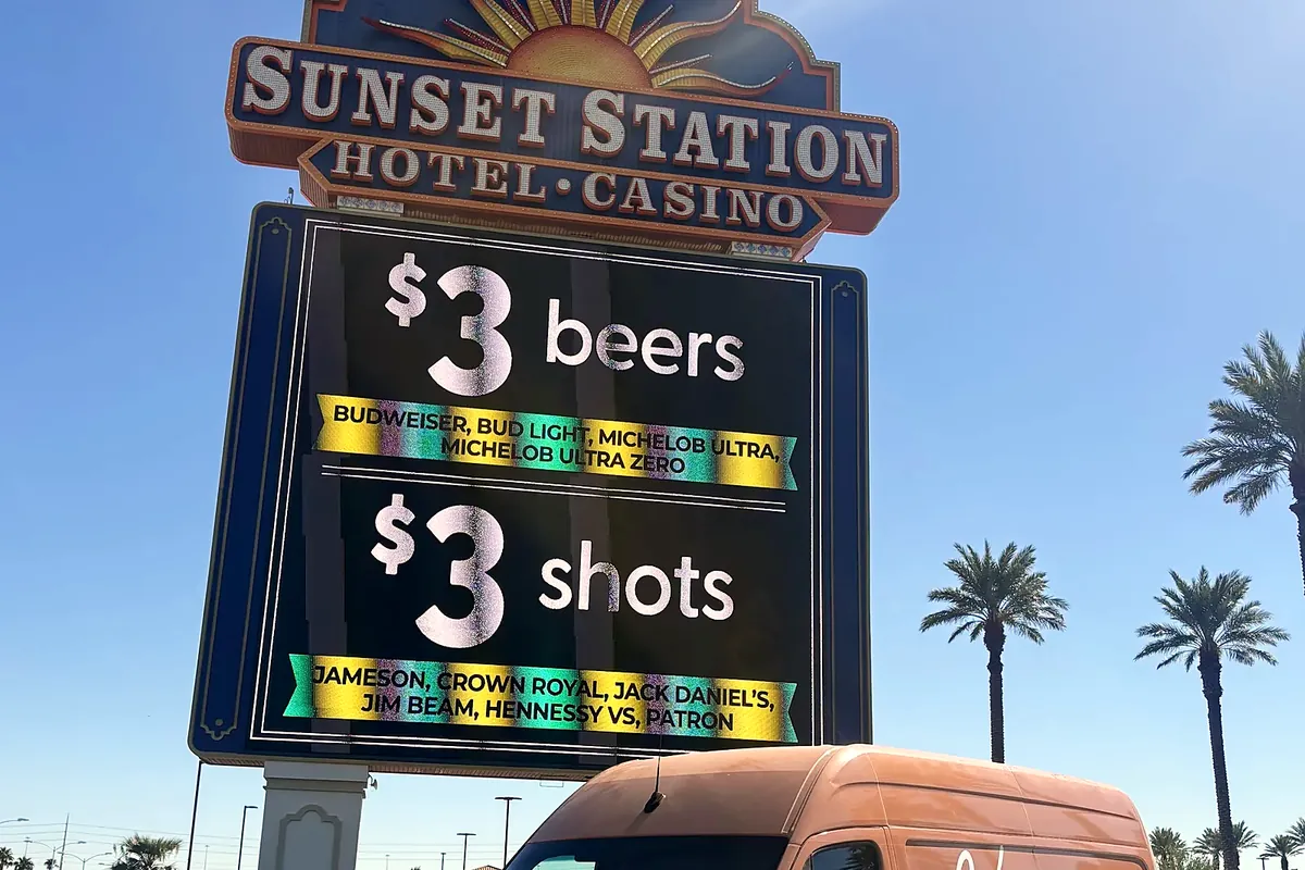 Kingdom Plumbing service van by the Sunset Station sign in Henderson