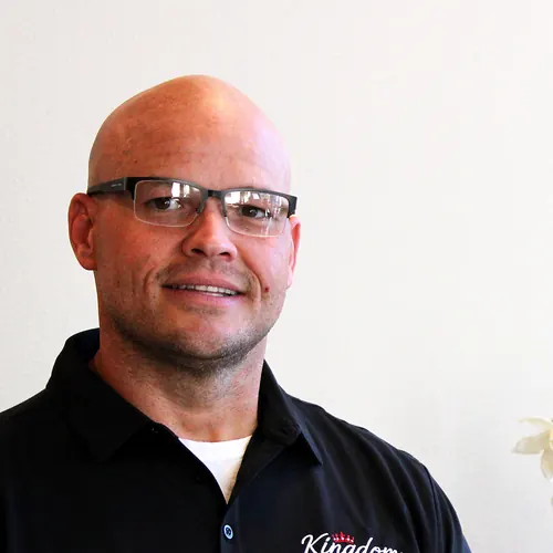 Kingdom Plumbing team member in rimless glasses, serving Las Vegas homes