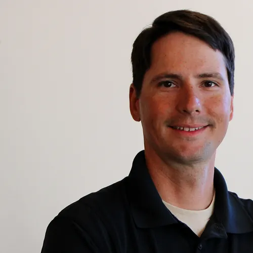 Smiling Kingdom Plumbing team member with short dark hair, Las Vegas plumbing crew