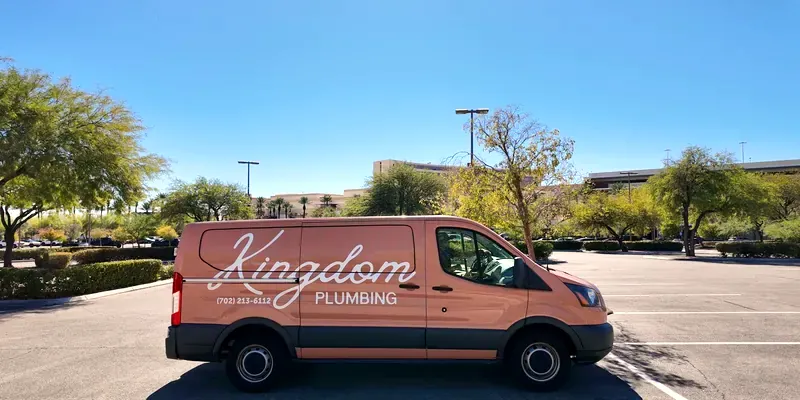 Kingdom Plumbing service van in a Las Vegas parking lot