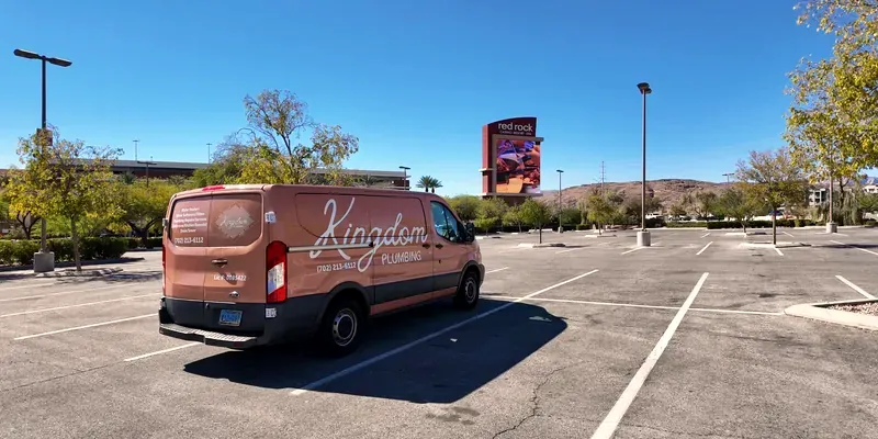 Kingdom Plumbing service van in a Las Vegas parking lot