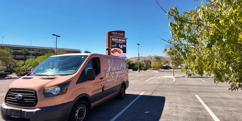 Kingdom Plumbing service van in a Las Vegas parking lot