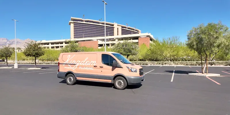 Kingdom Plumbing service van in a Las Vegas parking lot